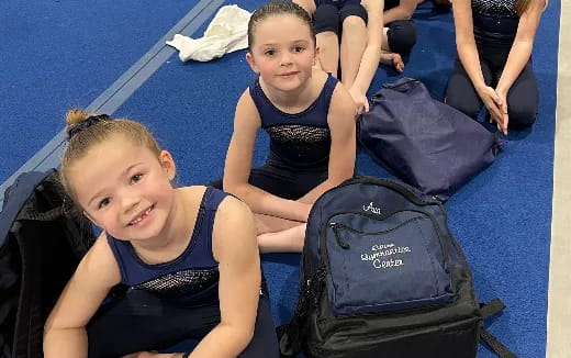 a couple of girls in swimsuits in a pool