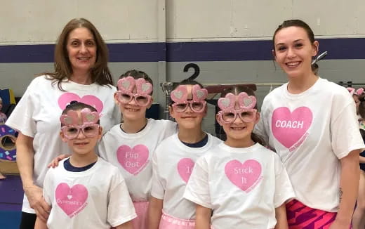 a group of people wearing pink and white shirts