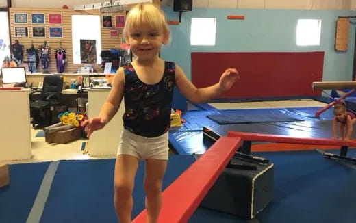 a girl standing on a mat