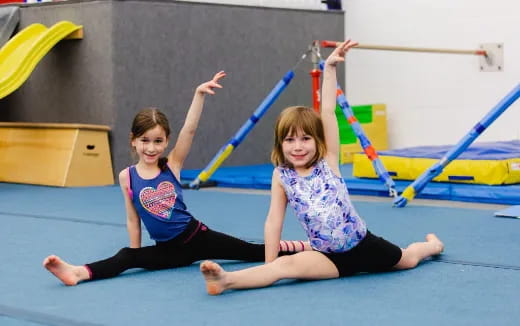 a couple of girls on a mat