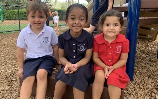 a group of children sitting on a slide