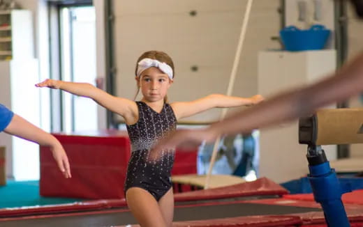 a woman in a leotard in a gym