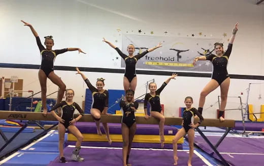 a group of women jumping in a competition