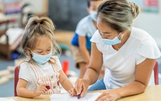 a person and a girl looking at a paper