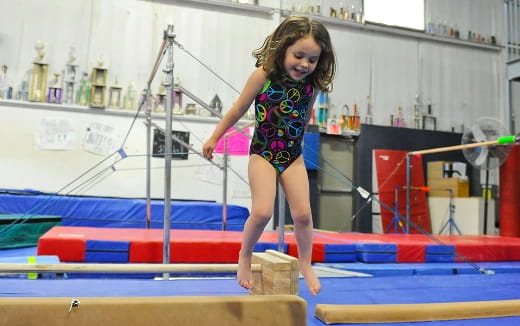 a girl jumping on a trampoline