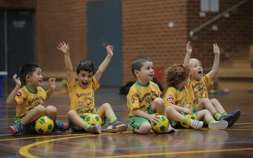 a group of kids playing basketball