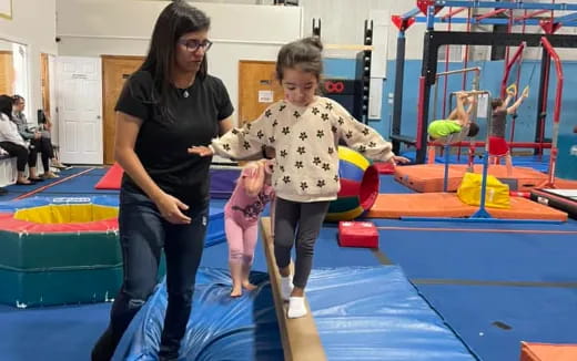 a person and a child playing on a trampoline