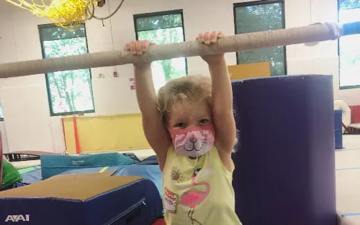 a child holding a large wooden sword