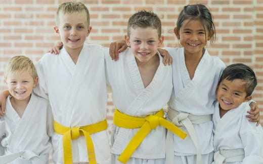 a group of children in white shirts