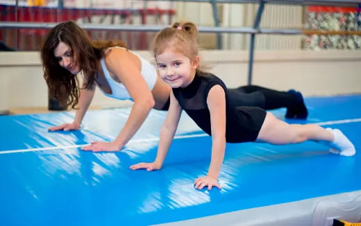 a person and a girl in a swimming pool