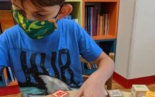 a boy holding a blue shirt