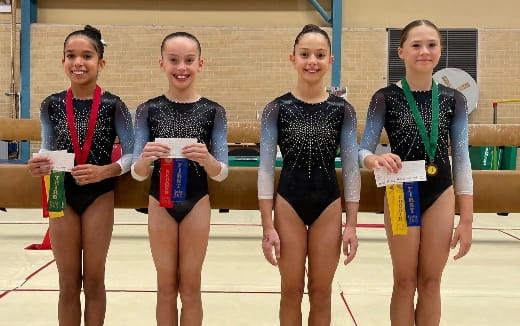 a group of women wearing medals