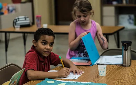 a few children working on a laptop