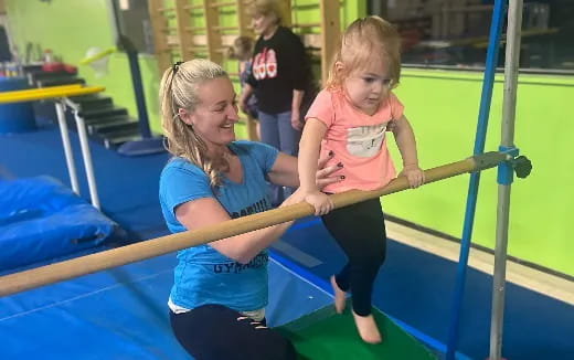 a person and a girl playing on a trampoline