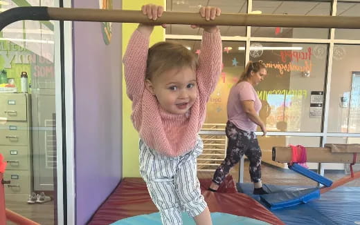 a girl standing on a mat