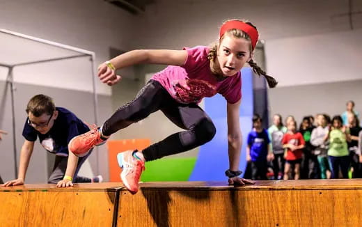 a person jumping on a wooden platform