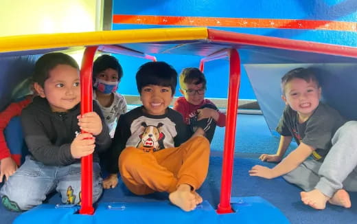 a group of kids sitting on a slide