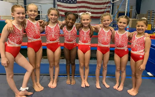 a group of girls in swimsuits posing for a photo