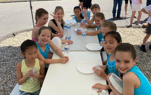 a group of children eating at a table