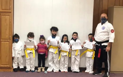 a group of children in karate uniforms