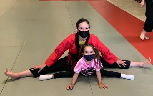 a person and a girl on a mat
