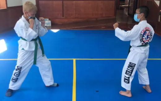 a couple of men in karate uniforms