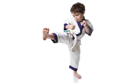a boy in a karate uniform