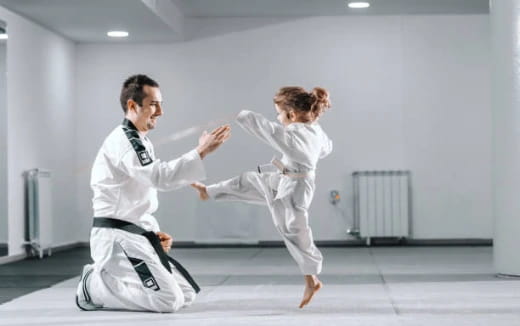 a man and a woman in karate uniforms