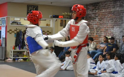 two people in white uniforms fighting