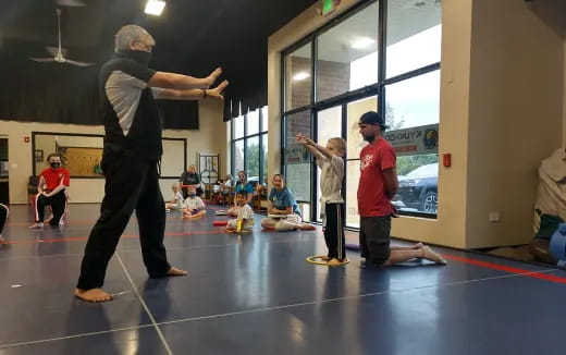 a person dancing in a room with other people