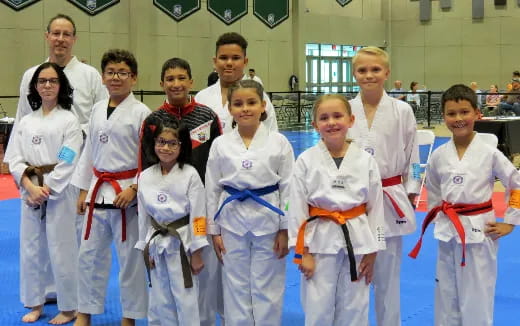 a group of people wearing white karate uniforms