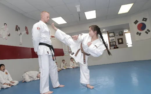 a man and woman in karate uniforms