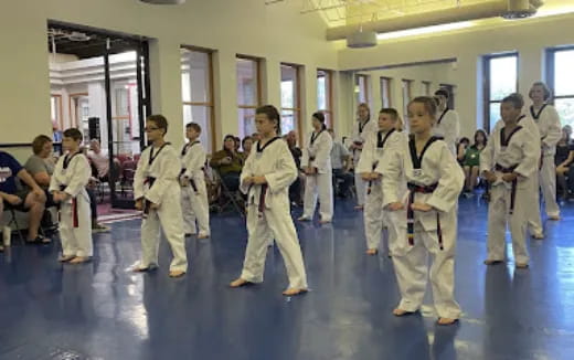 a group of people in white karate uniforms