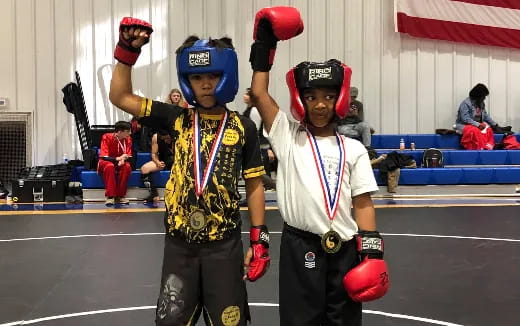 a couple of people wearing helmets and holding balls