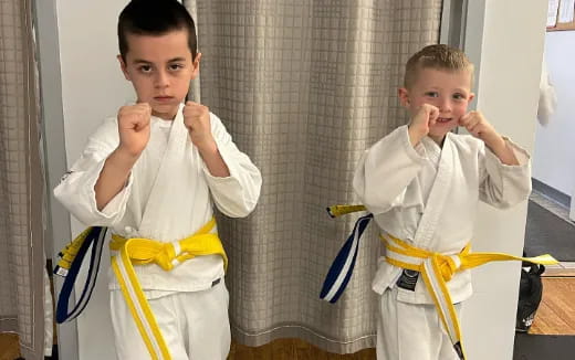 a couple of boys in karate uniforms