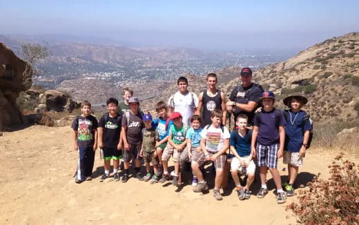 a group of people posing for a photo on a mountain