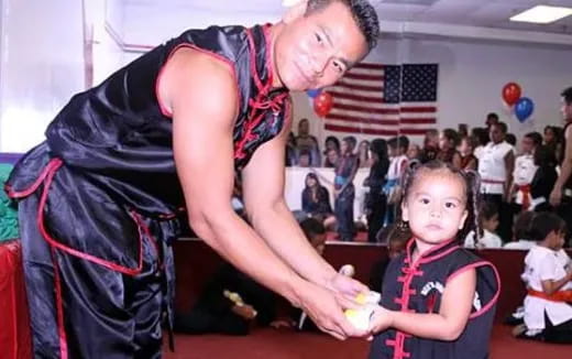 a person helping a girl with the hands