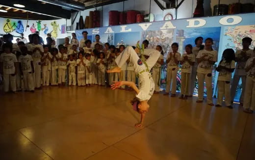 a person dancing in front of a crowd of people