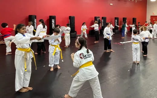 a group of children in karate uniforms