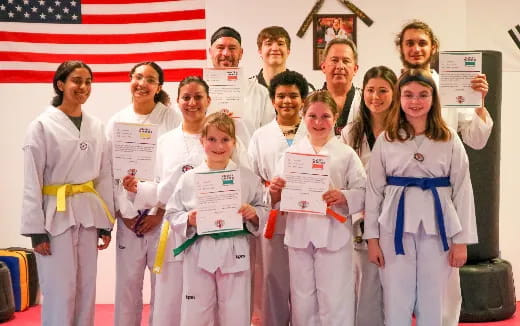 a group of people holding certificates