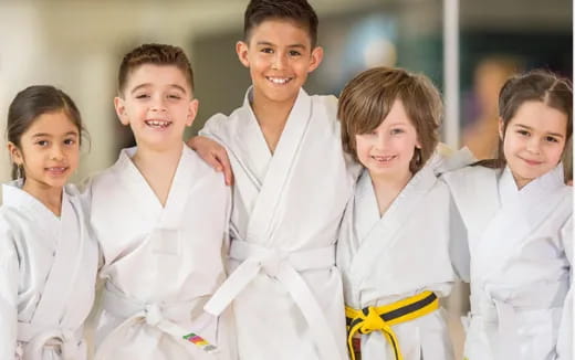 a group of children wearing white lab coats