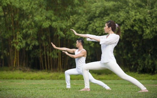 a man and woman practicing martial arts