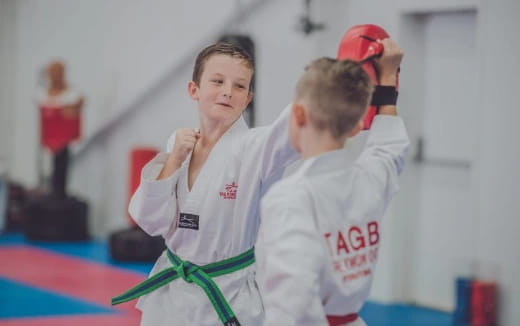 a couple of men in karate uniforms
