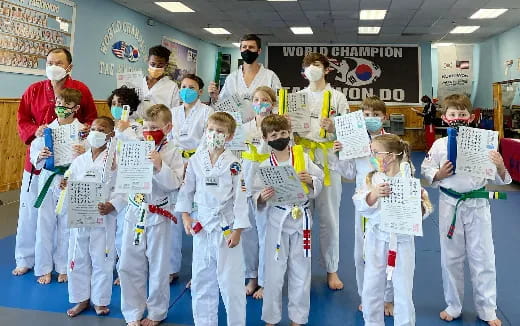 a group of people wearing white karate uniforms