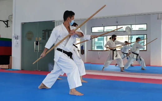 a group of people in karate uniforms