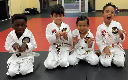 a group of kids in karate uniforms