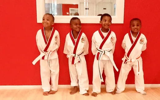 a group of boys in karate uniforms