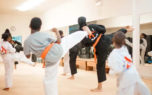 a group of people in karate uniforms