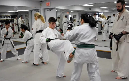 a group of people in white karate uniforms