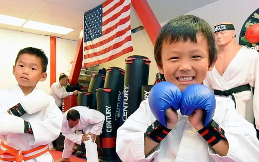 a group of kids in karate uniforms
